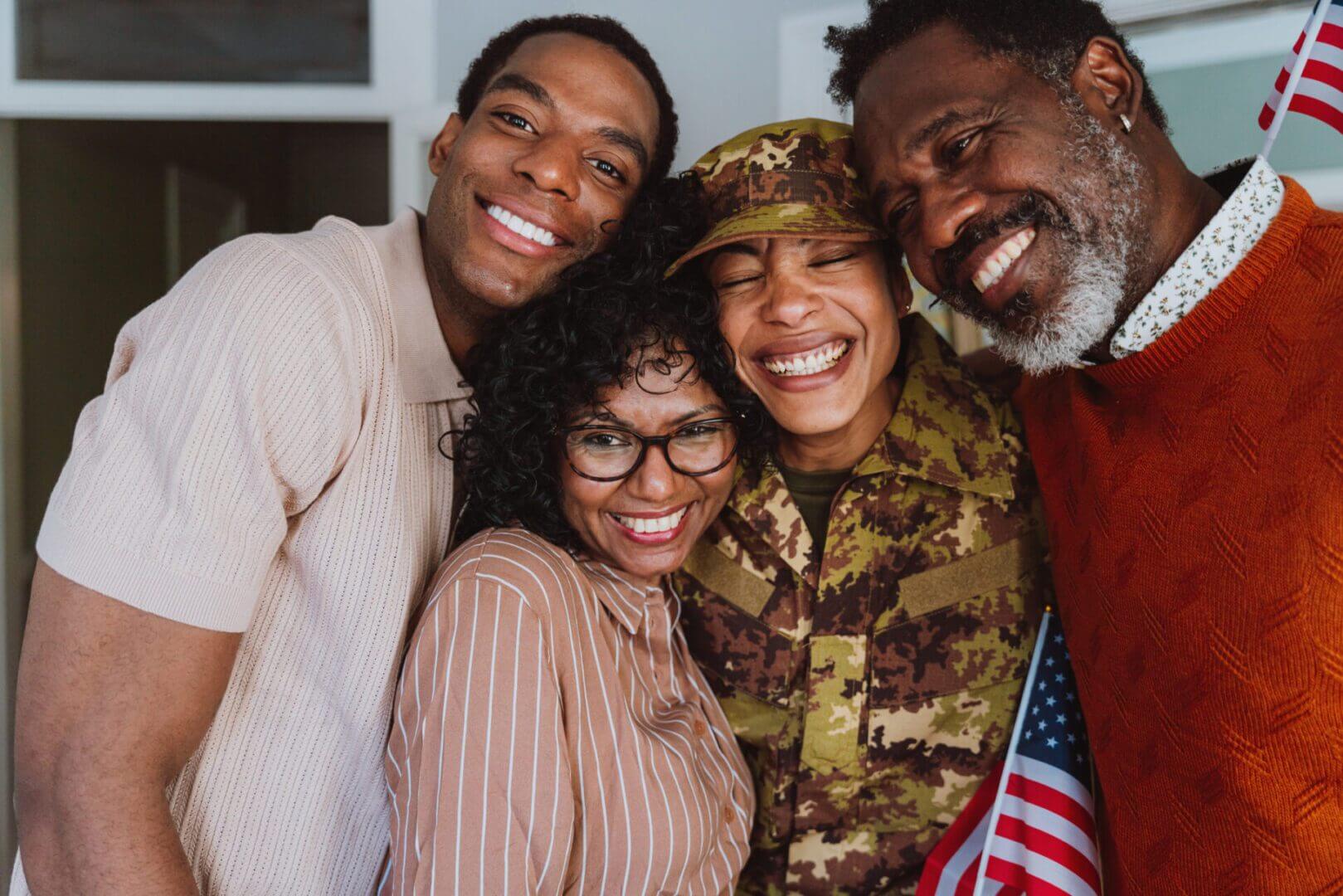 A joyful family smiling together, with one member in military uniform.